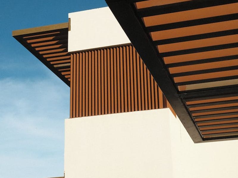 Person sitting calmly in a modern, minimalist room.